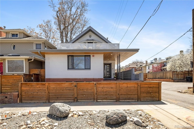 1922 E 18th Ave, Denver, CO 80206 - view of front of home with brick siding and a fenced front yard