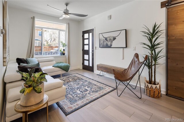 1922 E 18th Ave, Denver, CO 80206 - living room with light wood-style flooring, ceiling fan, and baseboards