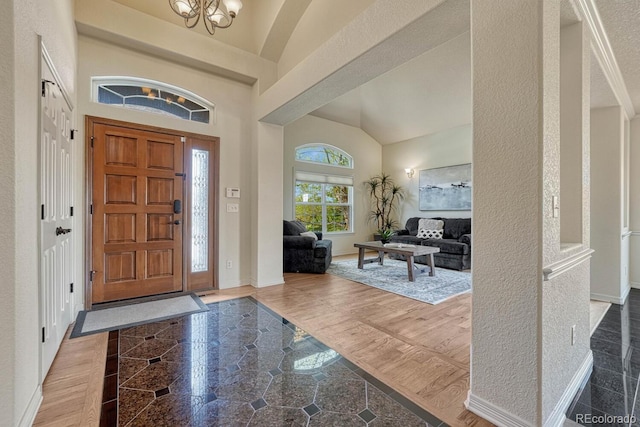 580 Eagle Nest Ct, Golden, CO 80401 - foyer featuring a chandelier, lofted ceiling, and baseboards
