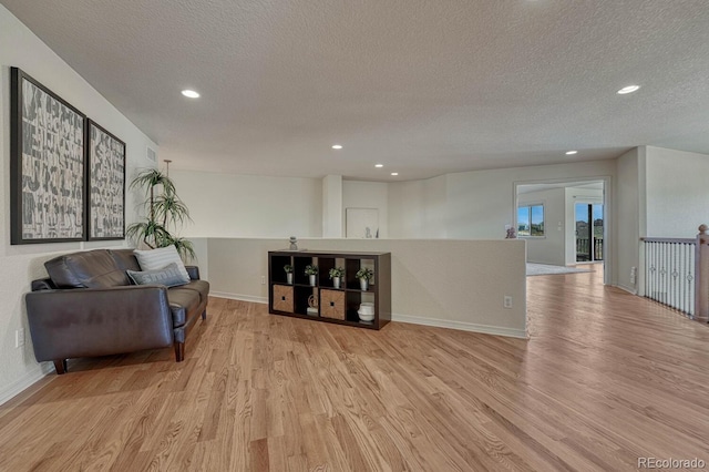 580 Eagle Nest Ct, Golden, CO 80401 - sitting room with a textured ceiling, light wood-type flooring, recessed lighting, and baseboards