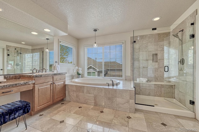 580 Eagle Nest Ct, Golden, CO 80401 - full bathroom with a textured ceiling, a shower stall, vanity, a bath, and recessed lighting