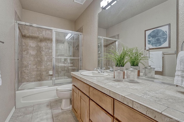 580 Eagle Nest Ct, Golden, CO 80401 - bathroom with a textured wall, vanity, toilet, a textured ceiling, and enclosed tub / shower combo