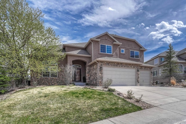 580 Eagle Nest Ct, Golden, CO 80401 - view of front of home with stone siding, driveway, an attached garage, and stucco siding