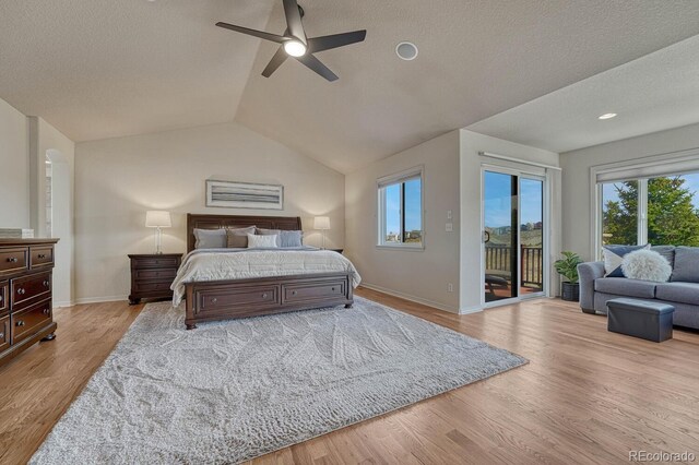 580 Eagle Nest Ct, Golden, CO 80401 - bedroom featuring access to exterior, multiple windows, baseboards, a textured ceiling, and lofted ceiling