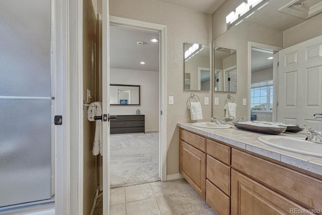 580 Eagle Nest Ct, Golden, CO 80401 - full bathroom featuring tile patterned floors, double vanity, and a textured wall