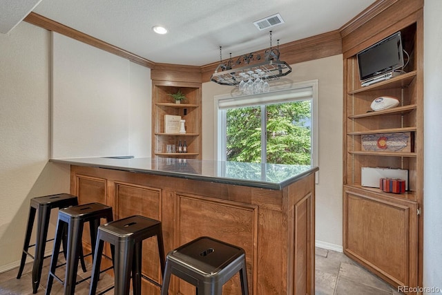 580 Eagle Nest Ct, Golden, CO 80401 - indoor dry bar featuring ornamental molding, built in features, baseboards, and a textured ceiling