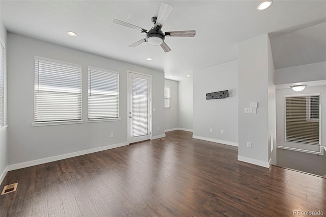 unfurnished living room featuring dark hardwood / wood-style flooring and ceiling fan