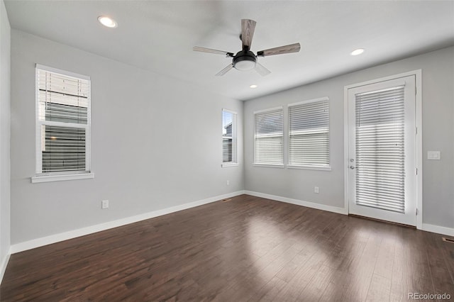 spare room with ceiling fan and dark hardwood / wood-style flooring