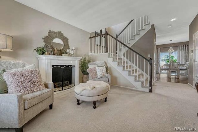 18655 E Garden Pl, Aurora, CO 80015 - carpeted living room featuring stairs, baseboards, and a fireplace