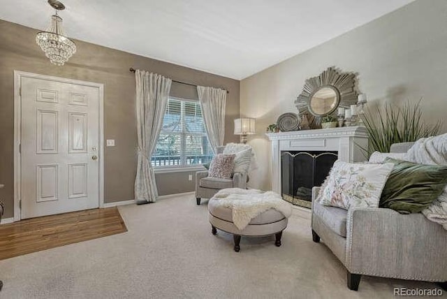 18655 E Garden Pl, Aurora, CO 80015 - carpeted living room featuring a chandelier, baseboards, and a fireplace