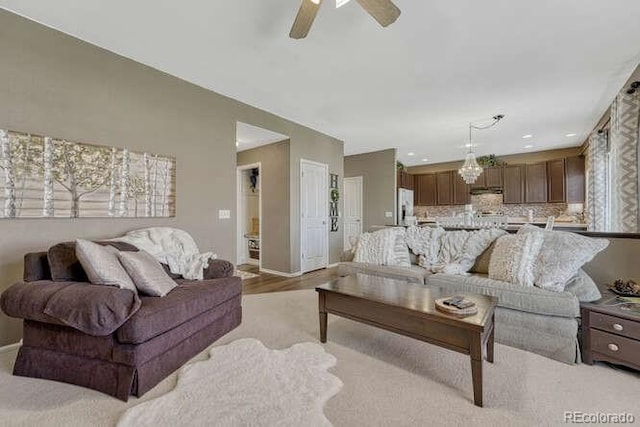18655 E Garden Pl, Aurora, CO 80015 - living area featuring baseboards, a ceiling fan, and light wood-style flooring