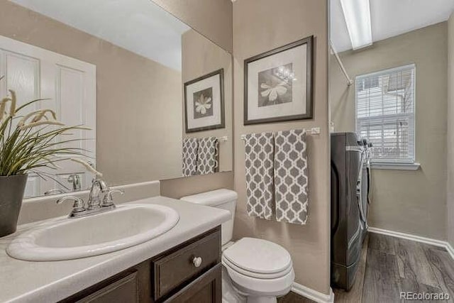 18655 E Garden Pl, Aurora, CO 80015 - full bathroom featuring toilet, vanity, wood finished floors, baseboards, and a shower