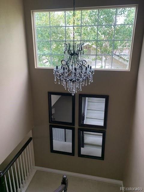 18655 E Garden Pl, Aurora, CO 80015 - stairway with a chandelier