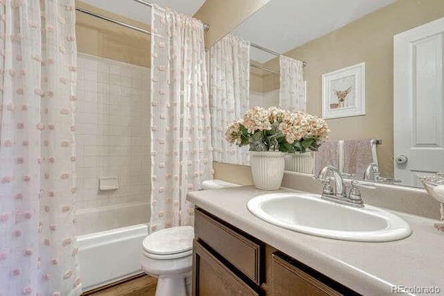 18655 E Garden Pl, Aurora, CO 80015 - bathroom featuring vanity, shower / tub combo with curtain, and toilet
