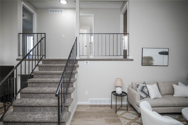 stairs with hardwood / wood-style flooring