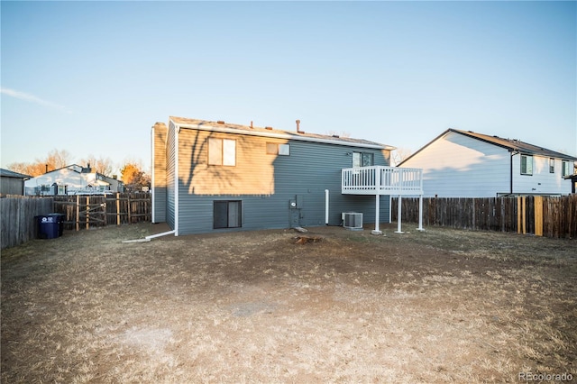 rear view of property featuring central AC