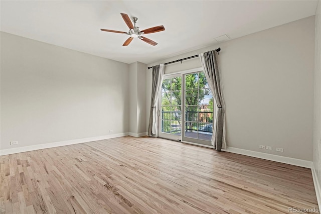 spare room featuring light hardwood / wood-style flooring and ceiling fan