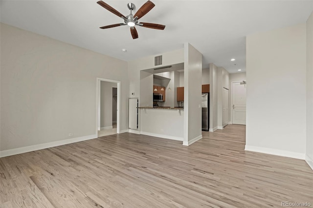 unfurnished living room with light hardwood / wood-style floors and ceiling fan