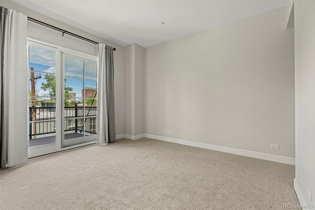 unfurnished room featuring light carpet