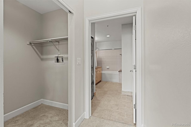 laundry room featuring light carpet and washer hookup