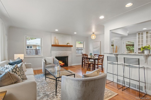 5315 Newland St, Arvada, CO 80002 - living area featuring a fireplace, wood finished floors, recessed lighting, and baseboards