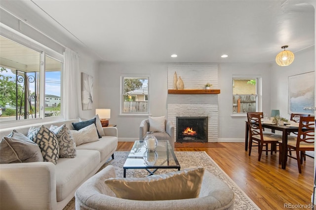 5315 Newland St, Arvada, CO 80002 - living room featuring healthy amount of natural light, a fireplace, wood finished floors, baseboards, and recessed lighting