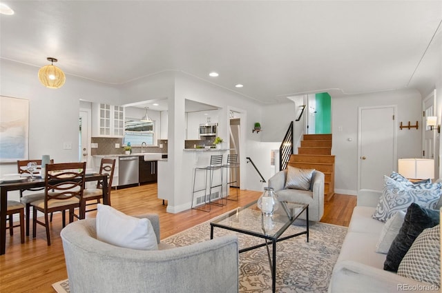5315 Newland St, Arvada, CO 80002 - living room with light wood finished floors, stairway, and recessed lighting