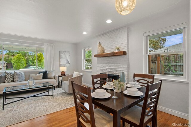 5315 Newland St, Arvada, CO 80002 - dining room featuring light wood finished floors, baseboards, a large fireplace, and recessed lighting