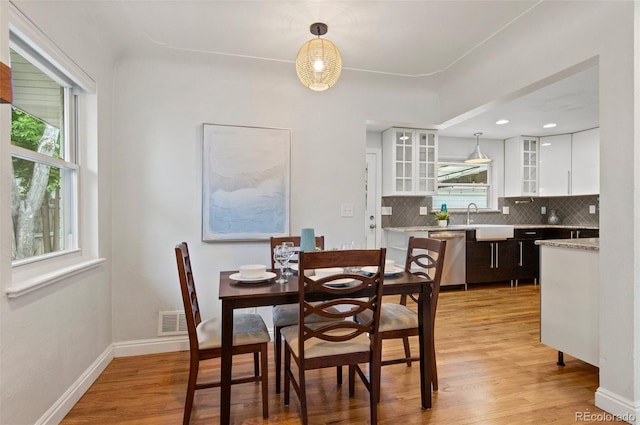 5315 Newland St, Arvada, CO 80002 - dining space with plenty of natural light, light wood-type flooring, and baseboards