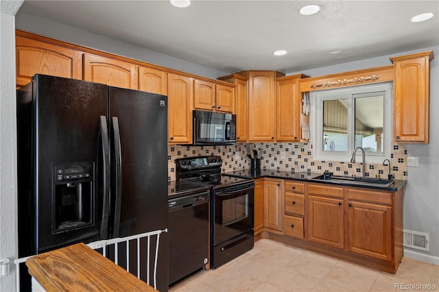 160 Northglenn Dr, Northglenn, CO 80233 - kitchen featuring black appliances, a sink, dark countertops, decorative backsplash, and recessed lighting