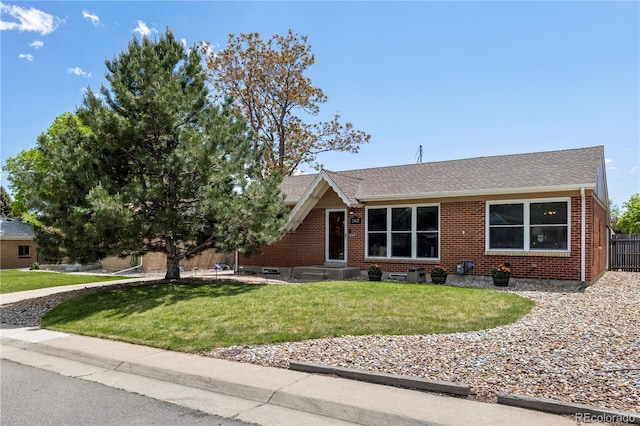 160 Northglenn Dr, Northglenn, CO 80233 - view of front of property with brick siding and roof with shingles