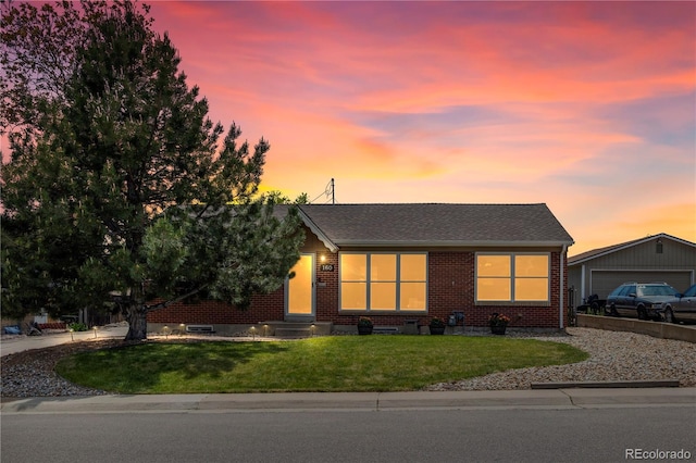 160 Northglenn Dr, Northglenn, CO 80233 - view of front of property with brick siding, a front lawn, a garage, and roof with shingles