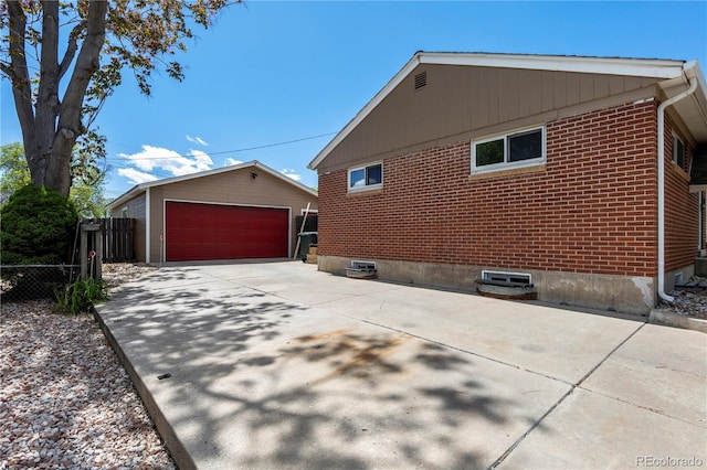 160 Northglenn Dr, Northglenn, CO 80233 - view of side of home with a garage, brick siding, and an outbuilding