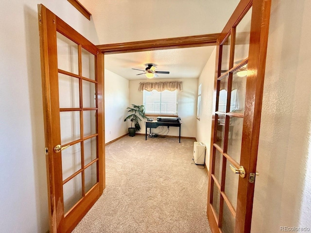 hall with french doors and light carpet