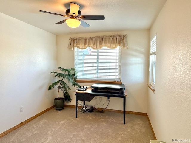 carpeted office featuring ceiling fan