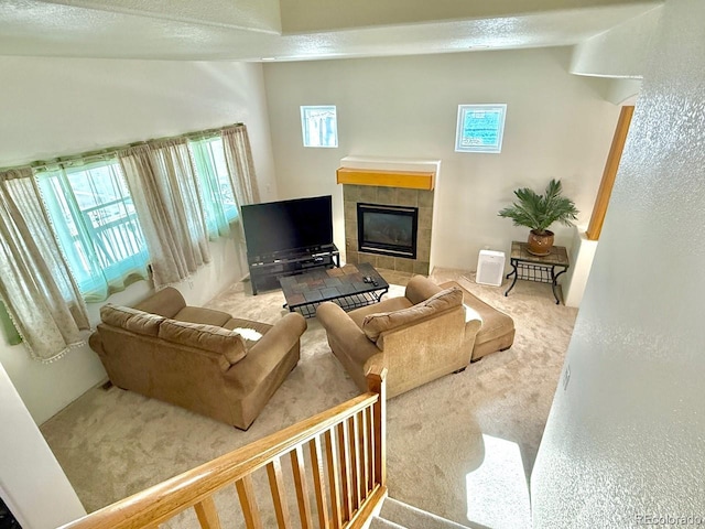 living room featuring light carpet and a tile fireplace