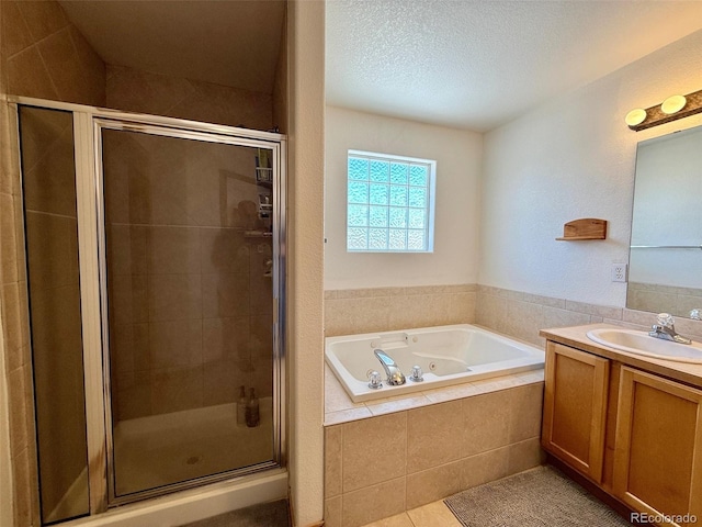 bathroom featuring vanity, separate shower and tub, tile patterned floors, and a textured ceiling