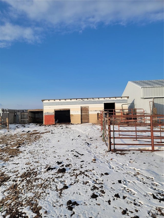 snowy yard with an outbuilding