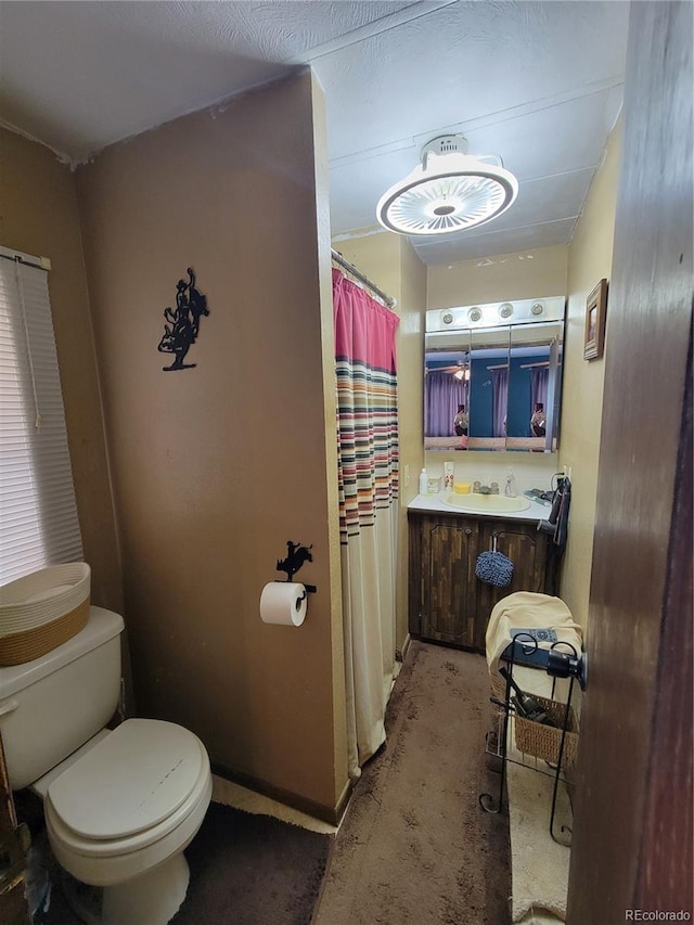 bathroom with concrete flooring, sink, and toilet