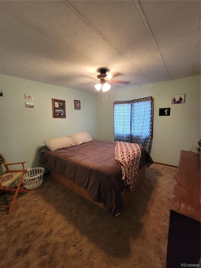 bedroom featuring dark colored carpet and ceiling fan