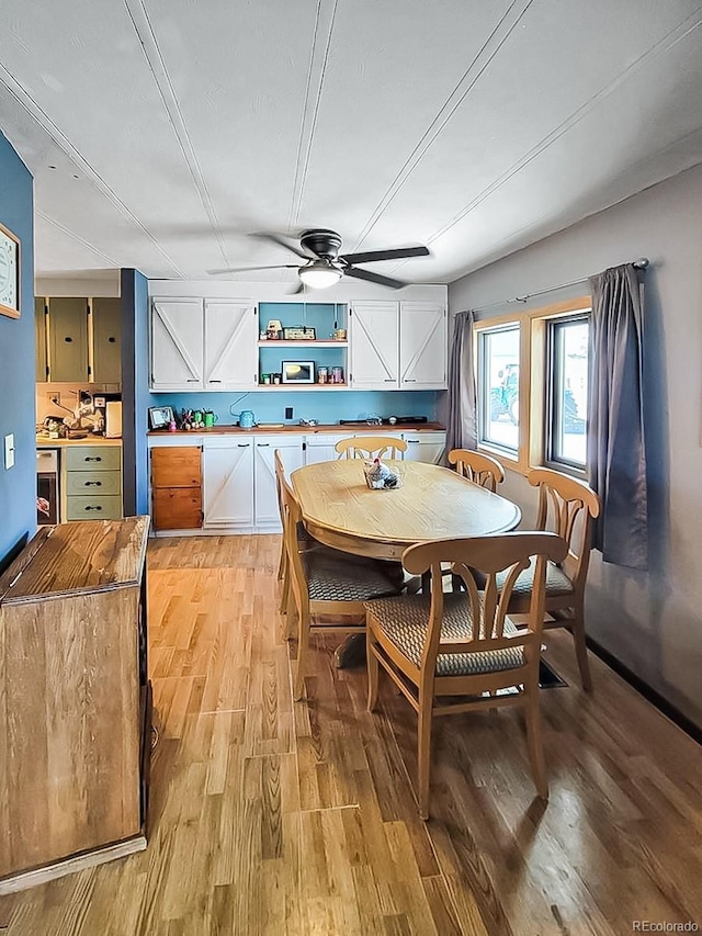 dining room featuring ceiling fan and light hardwood / wood-style floors