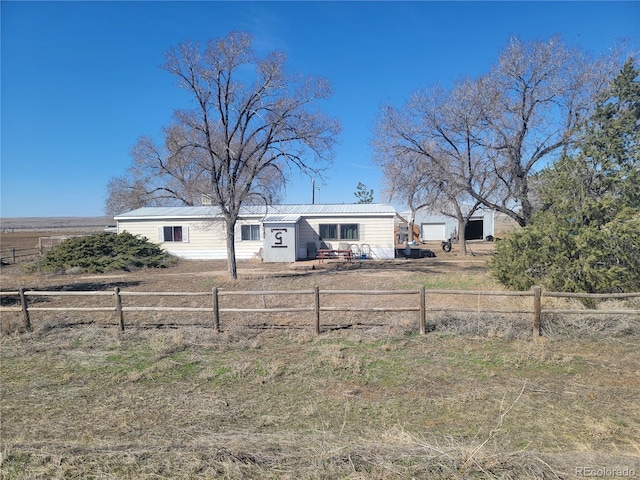 view of front facade featuring a fenced front yard and metal roof