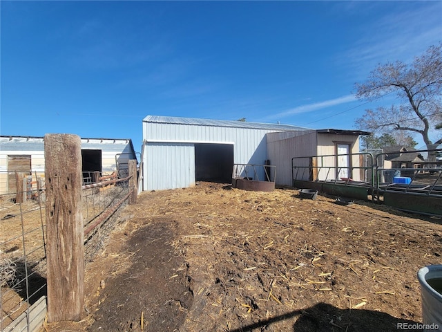 view of pole building featuring fence