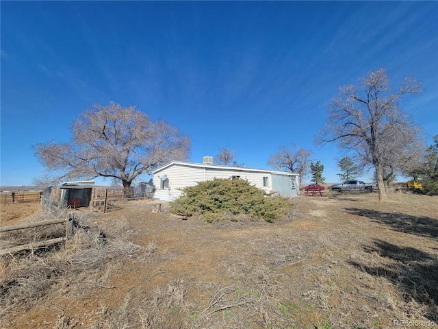 exterior space featuring an outbuilding and fence