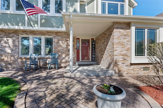 view of exterior entry with brick siding