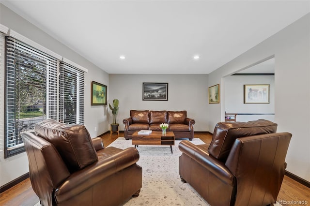 living area with recessed lighting, baseboards, and light wood finished floors