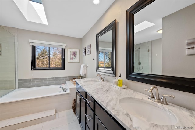 full bathroom featuring a sink, a skylight, a stall shower, and a garden tub