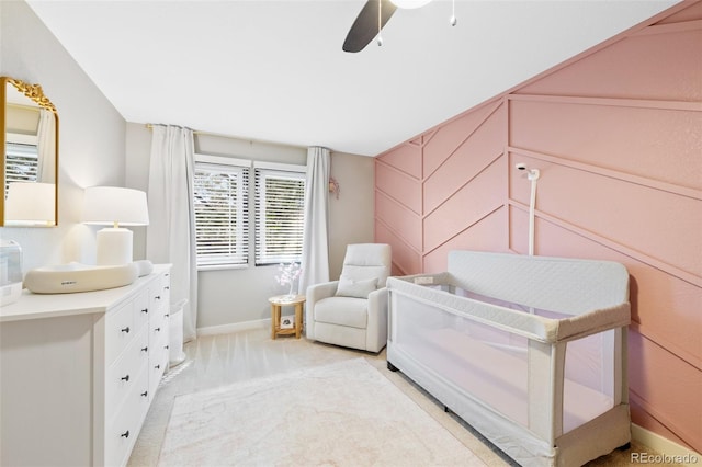 bedroom with baseboards, a ceiling fan, and light colored carpet