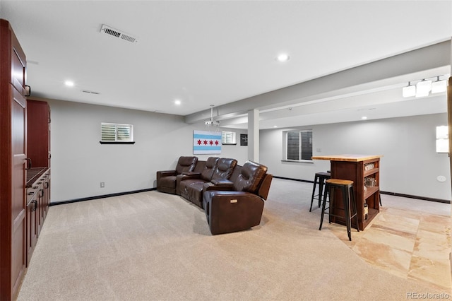 living area with baseboards, light carpet, recessed lighting, and visible vents