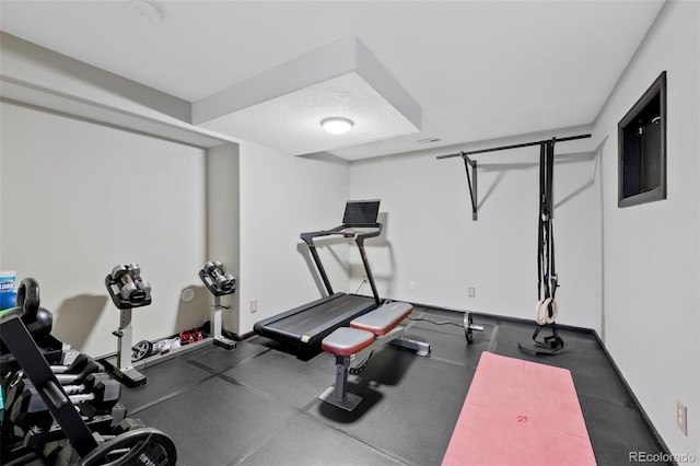 workout area featuring baseboards